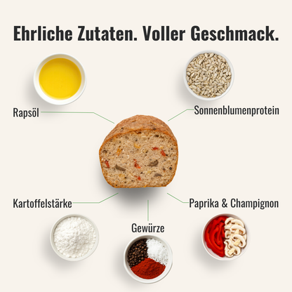 Eine Übersicht von Zutaten die im veganen Pizza Leberkäse zum Selbstbacken sind, welcher in der Mitte liegt, verwendet werden.
